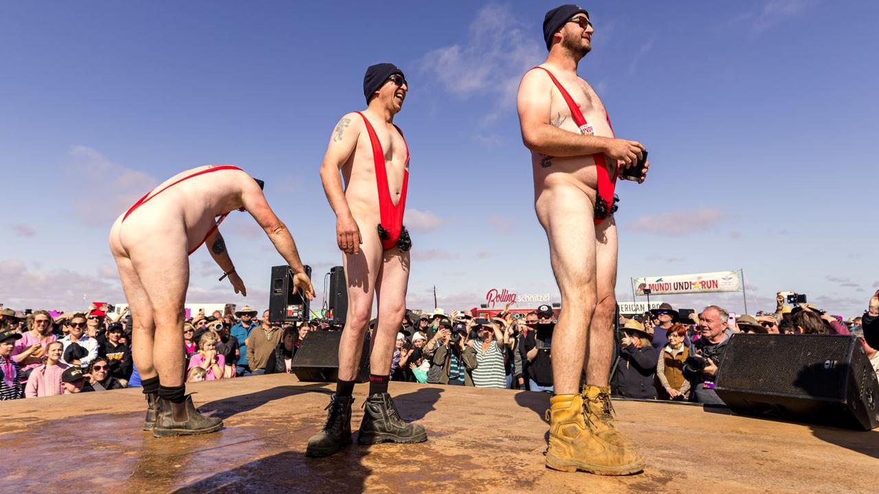 The three men rocking red mankinis and wigs. Picture: Matt Williams