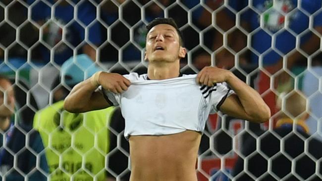 Germany's midfielder Mesut Oezil reacts after missing a penalty.