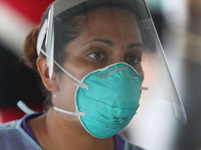 MIAMI LAKES, FLORIDA - JULY 22: A health care worker checks people in for a COVID-19 test at a testing site locate at the Miami Lakes Youth Center on July 22, 2020 in Miami Lakes, Florida. Testing is being provided by doctors from New York City associated with SOMOS Community Care, as the state of Florida experiences a surge in coronavirus cases.   Joe Raedle/Getty Images/AFP == FOR NEWSPAPERS, INTERNET, TELCOS & TELEVISION USE ONLY ==