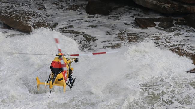 The Westpac rescue helicopter searches for a person missing in the ocean off Bondi. Picture: Toby Zerna