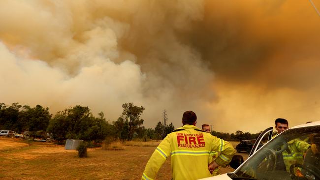 Thick smoke from bushfires fills the sky on Old Mill Rd near Tingha. Picture: Nathan Edwards