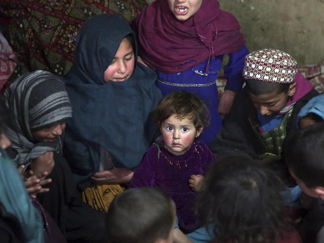 In this Sunday, March 19, 2017 photo, children play in their home in Kabul, Afghanistan. An aid group said Wednesday, March 22, 2017 that nearly a third of all children in war-torn Afghanistan are unable to attend school, leaving them at increased risk of child labor, recruitment by armed groups, early marriage and other forms of exploitation. (AP Photos/Massoud Hossaini)