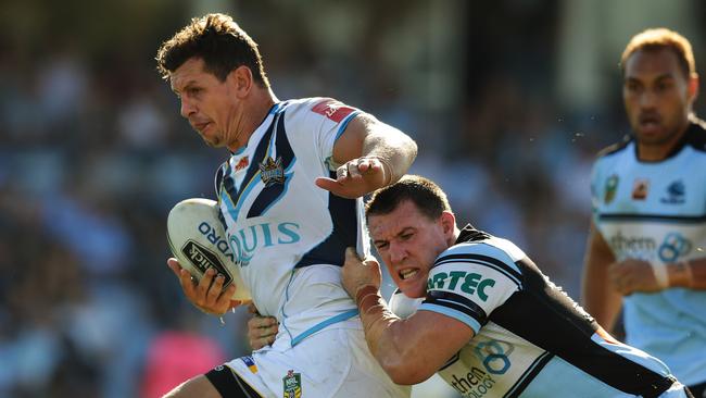 Titans Greg Bird is tackled by Cronulla's Paul Gallen during the Cronulla Sharks v Gold Coast Titans rugby league game at Shark Park, Cronulla. Pic Brett Costello