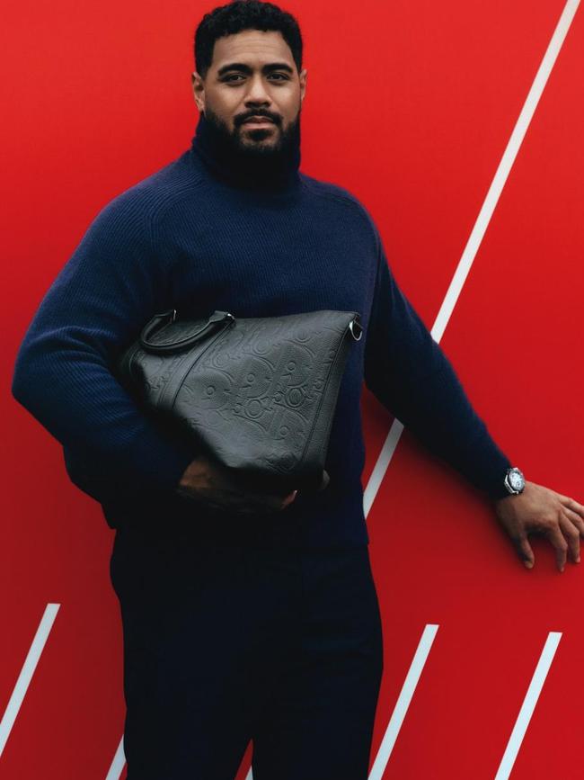Mailata wears woollen knit, by Hugo Boss; calfskin and leather Weekender 40 bag, by Dior Men.