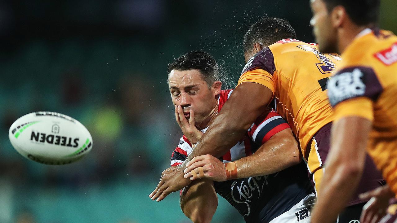 Roosters' Cooper Cronk gets hit by Brisbane's Tevita Pangai jnr 