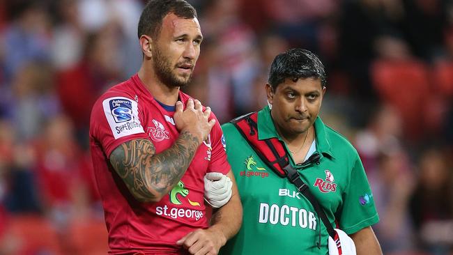 BRISBANE, AUSTRALIA - MAY 17: Quade Cooper of the Reds leaves the field injured during the round 14 Super Rugby match between the Reds and the Rebels at Suncorp Stadium on May 17, 2014 in Brisbane, Australia. (Photo by Chris Hyde/Getty Images)