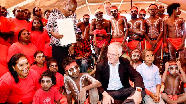 Then Prime Minister Malcolm Turnbull, traditional owner Raylene Singh and Kenbi dancersat the Kenbi Land Claim Title Deed Handover at Wagait Beach, Mandorah, in 2016.