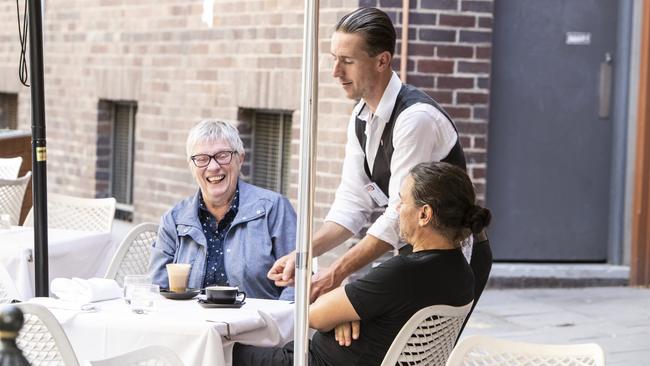 A waiter at Rigoni’s serves customers on Wednesday. Picture: Simon Cross 