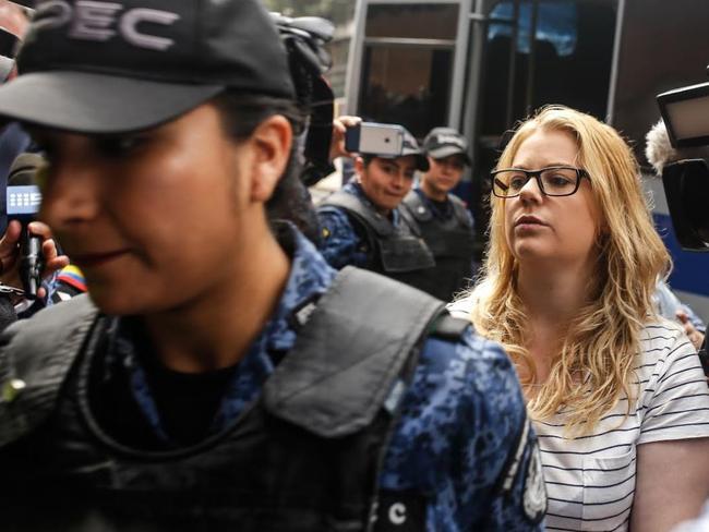 Cassie Sainsbury wades through the media pack as she arrives at a Bogota court in Colombia.  Picture:  Ivan Valencia