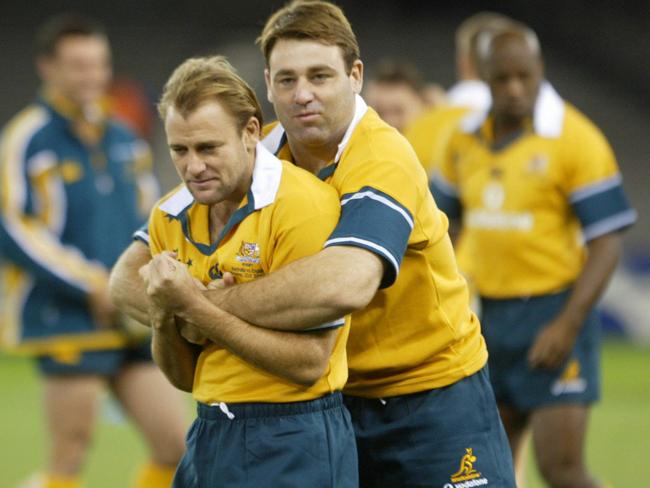 David Lyons gives his halfback Chris Whittaker a hug at Wallabies training in 2003.