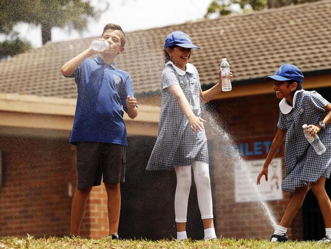 Kids from Merrylands East Public School cool off during Sydney's summer heat.  L to R, Eddie Budimlic, Susan Masomi and Disha Narsey.