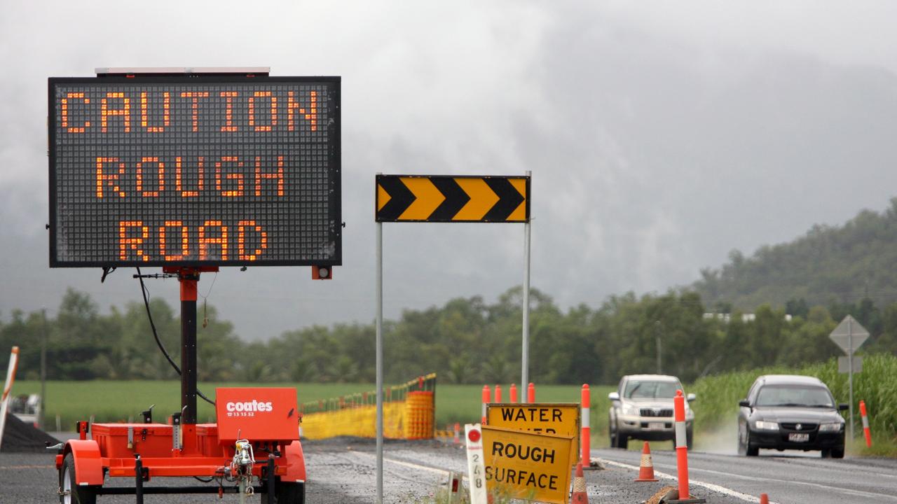 The Bruce Highway leading into Gordonvale has caution signs placed after rainfall in Far North Queensland.