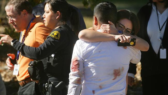 Sheer terror ... a couple embraces following the shooting. Picture: David Bauman/The Press-Enterprise via AP