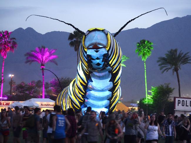 Not just about the music ... a giant caterpillar moves through the crowd. Picture: AFP PHOTO / ROBYN BECK