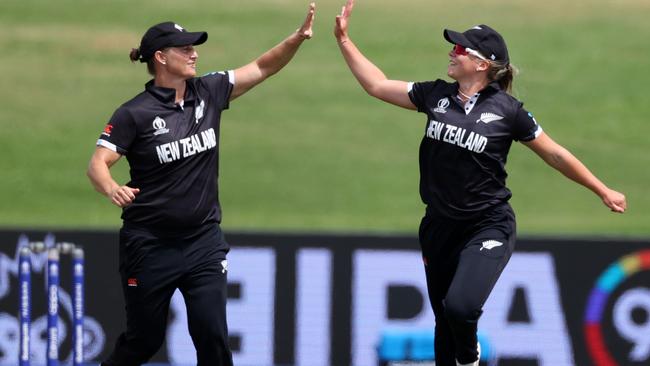 Devine celebrates a wicket with Jess Kerr.