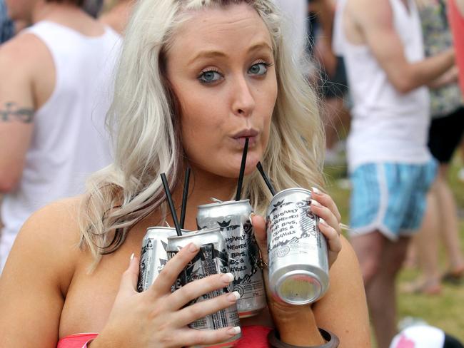 Too much? This young lady at a music festival could be carrying a few cans for others.