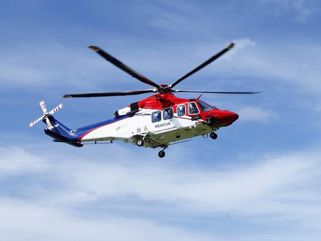 The QG Air 510 Rescue emergency services helicopter transports a 44 year old male spearfisherman to Cairns Hospital, after he was bitten multiple times by a 4.5 metre saltwater crocodile off Archer Point, south of Cooktown in Far North Queensland. Picture: Brendan Radke