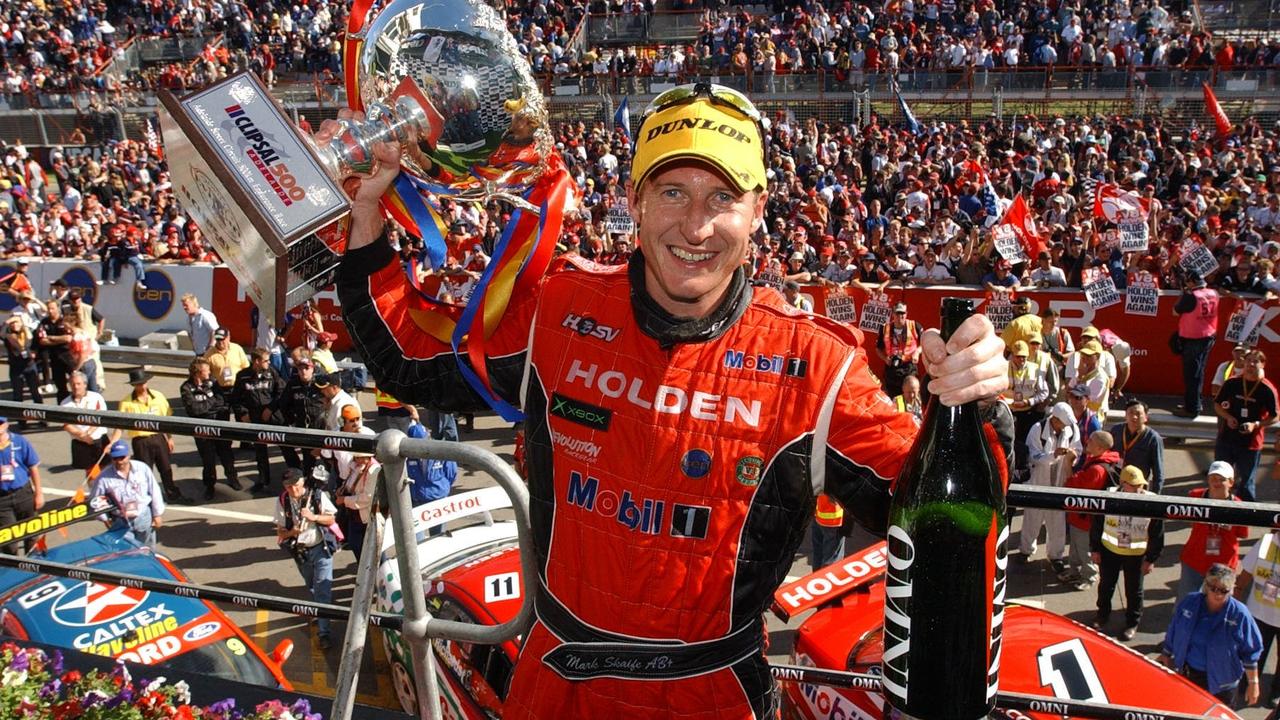 Supercars superstar Mark Skaife holds up his trophy after an iconic win in Adelaide in 2003.