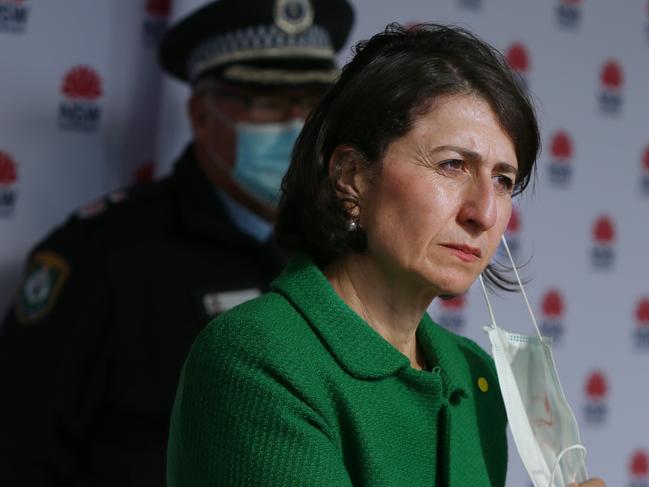 SYDNEY, AUSTRALIA - JUNE 24: Premier Gladys Berejiklian removes a face mask during a press conference on June 24, 2021 in Sydney, Australia. A steady increase in Covid-19 cases in Sydney prompted the government to impose greater restrictions including a mandatory mask mandate indoors and limits on gatherings and movement. Several Sydney suburbs have been declared federal Covid-19 hotspots. (Photo by Lisa Maree Williams/Getty Images)