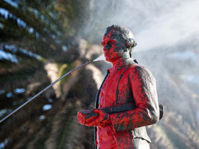 Captain Cook Memorial in Melbourne being cleaned after being vandalised with blood poured over the statue. Picture: Tony Gough