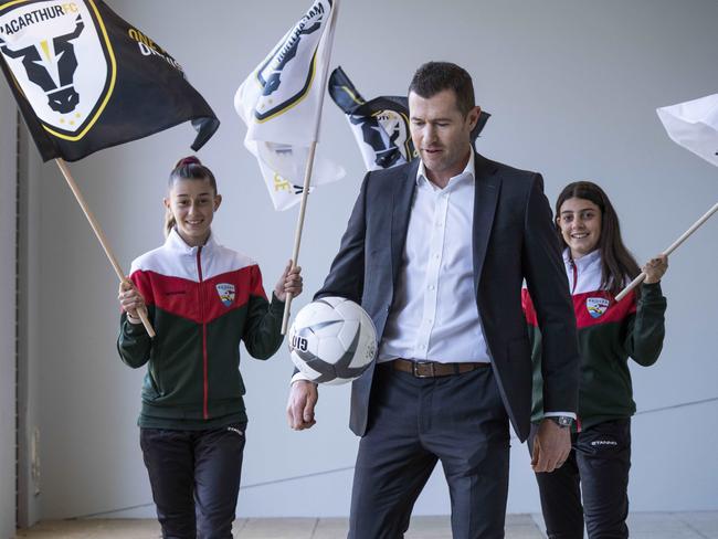Southern Districts Raiders players Kaleah Gribble and Caitlin Marra with club ambassador and former Socceroo Brett Emerton. Picture: Matthew Vasilescu