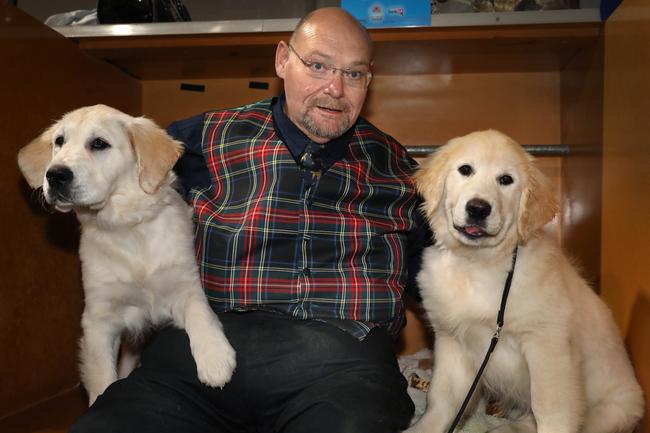 Mark Foylewith Puddles (L) and Winston (R), golden retrievers. Winston won best baby puppy boy Golden Retriever. Picture: Dean Martin