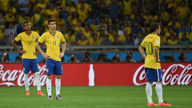 (L-R) Brazil's midfielder Luis Gustavo, Brazil's midfielder Oscar and Brazil's forward Bernard.