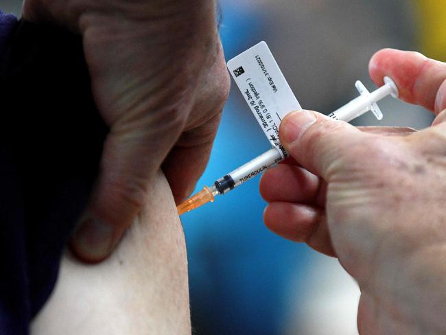 A health worker injecting the first dose of Pfizer vaccine to a member of the local Sikh community inside a Glenwood Sikh Temple in Sydney. Picture: AFP