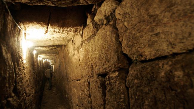 An Israeli archaeologist in 2007 walks along a drainage channel discovered next to Jerusalem's Old City. It was believed ancient Jews might have fled to the underground channel to escape the Romans. Picture: AP