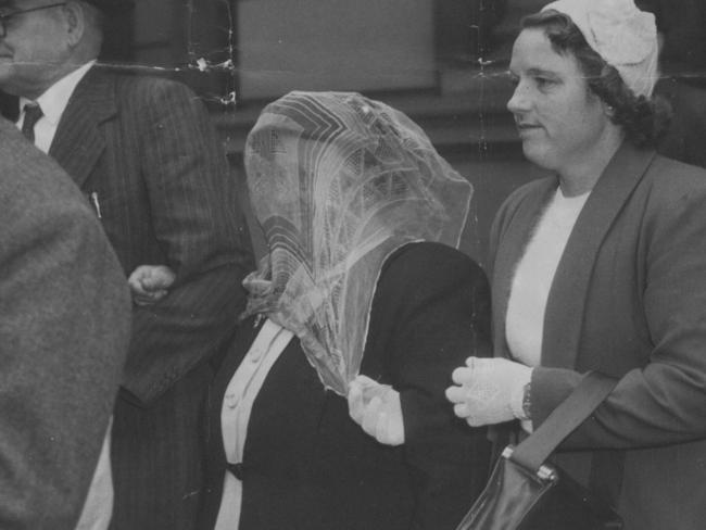 A veiled Grills is escorted to court for her trial. Picture: News Corp