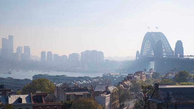 The Sydney Harbour Bridge is seen shrouded by smoke in Sydney on September 13, 2023, as a smoky haze blankets Australia's scenic Sydney Harbour, after a ring of controlled blazes burned on the city's fringes in preparation for the looming bushfire season. (Photo by Steve CHRISTO / AFP)