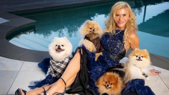 MELBOURNE, APRIL 22, 2022: Gamble Breaux and her Pomeranians will be taking part in a fashion show in St Kilda on Sunday. Picture: Mark Stewart NOTE: MANDATORY CREDIT The dogs wear the latest winter apparel from Doggone Gorgeous. Red gown: Gamble wears a gown by Aleem Yusuf Couture and hat by Kim Fletcher Millinery Blue gown: Gamble wears a gown by Aleem Yusuf Couture