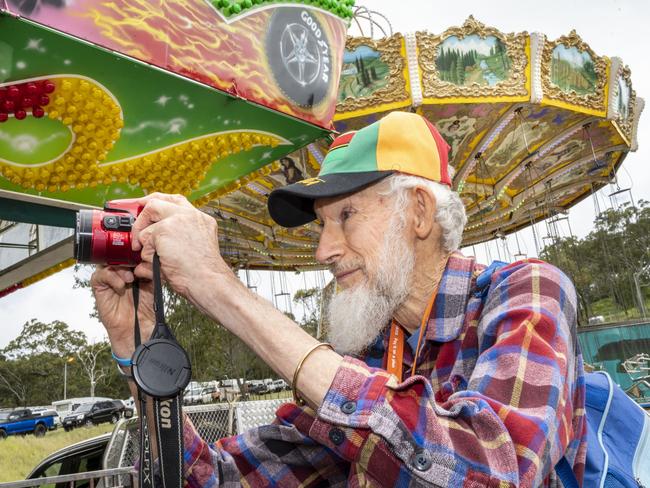 Photographer Robert Brown explores sideshow alley on day 3 of the Toowoomba Royal Show. Sunday, March 27, 2022. Picture: Nev Madsen.