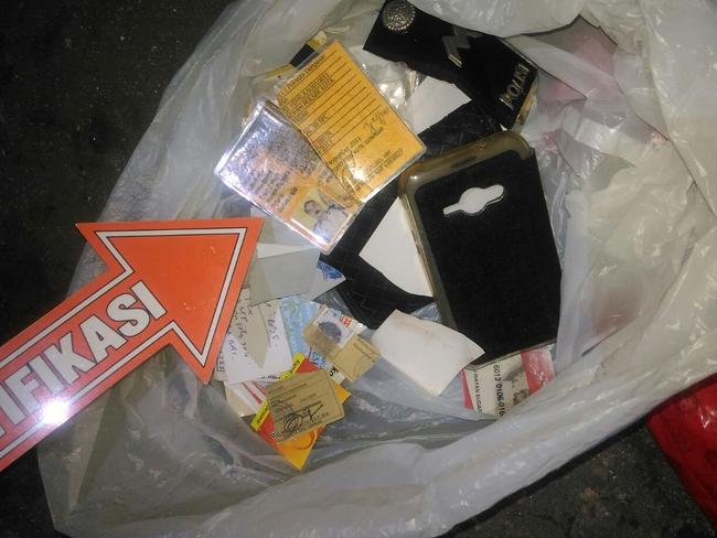 Murdered police officer Wayan Sudarsa's ID cards, wallet, tax card, driver’s licence, gun card, police rank insignia etc which were found by a local. Picture: Supplied