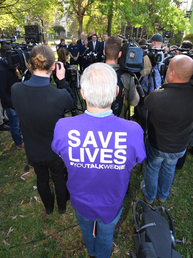 A man wearing a 'Save Lives’ shirt at Premier Daniel Andrews’ media conference. AAP Image/Joe Castro