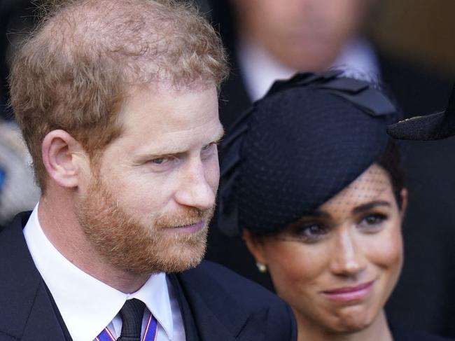 Britain's Prince Harry (L), Duke of Sussex, and Meghan (C), Duchess of Sussex, leave after paying their respects at Westminster Hall, at the Palace of Westminster, where the coffin of Queen Elizabeth II, will Lie in State on a Catafalque, in London on September 14, 2022. - Queen Elizabeth II will lie in state in Westminster Hall inside the Palace of Westminster, from Wednesday until a few hours before her funeral on Monday, with huge queues expected to file past her coffin to pay their respects. (Photo by Danny Lawson / POOL / AFP)