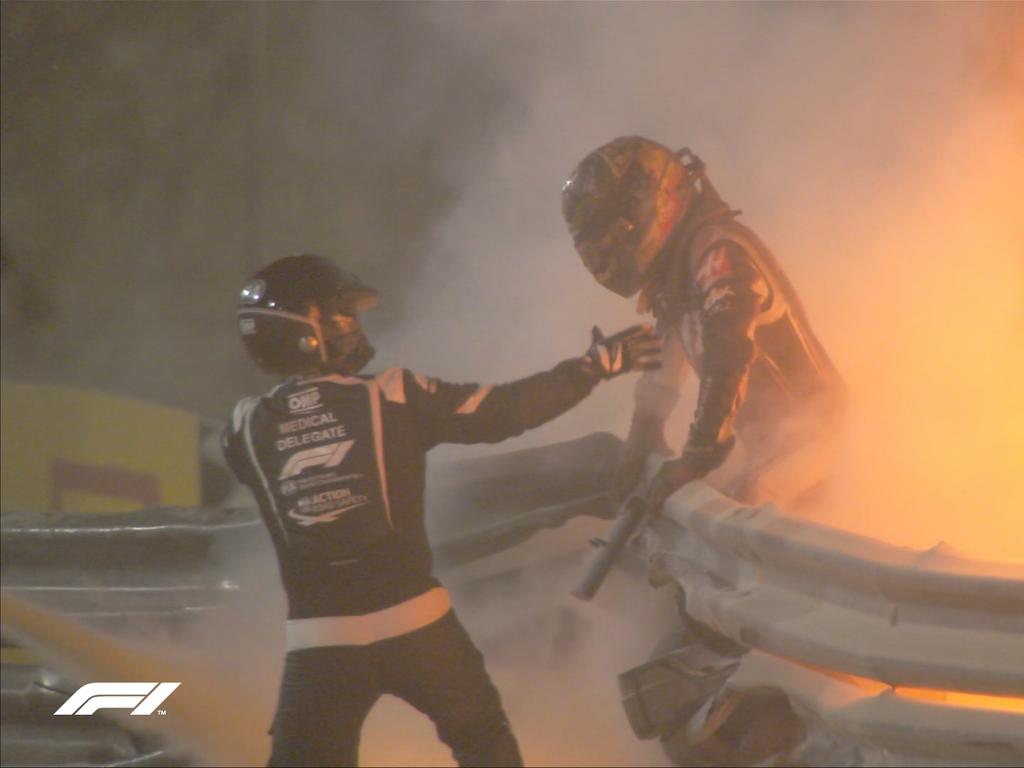 Grosjean climbs out of the flames.