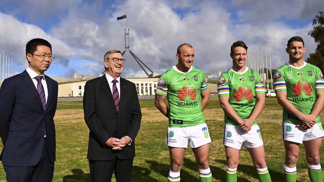 Canberra Raiders players Josh Hodgson, Jarrod Croker and Sam Williams pose for photographs with Huawei Technologies Australia Chairman John Lord (second left) and Huawei Australia CEO Hudson Liu (left) outside Parliament House in Canberra today. Picture: Lukas Coch/AAP