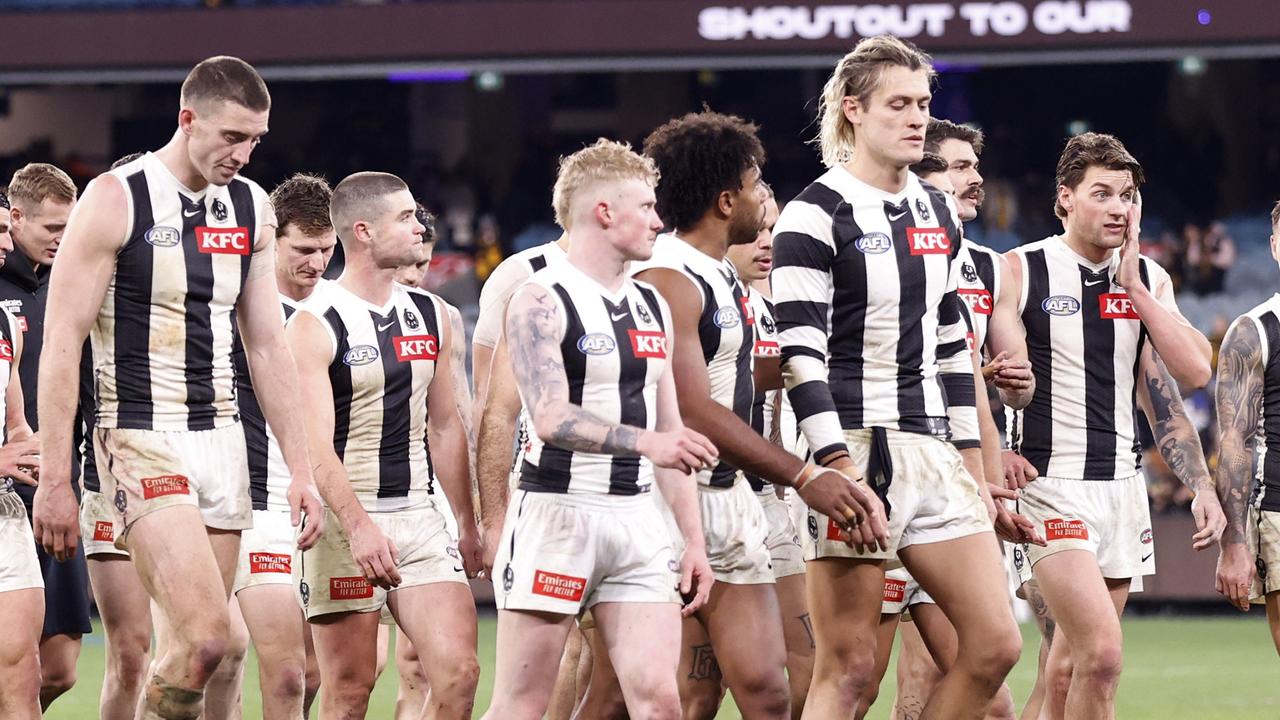 John Noble (centre) walks off next to Collingwood captain Darcy Moore after the Magpies’ 66-point loss to Hawthorn on Saturday. Picture: Darrian Traynor / Getty Images