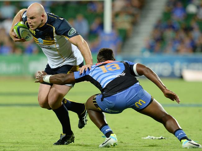 Stephen Moore brushes past the tackle of Western Force's Junior Rasolea.