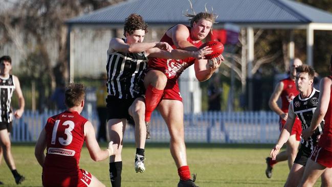 Two Wells star Jakob Thomson takes a strong mark. Picture: Peter Argent