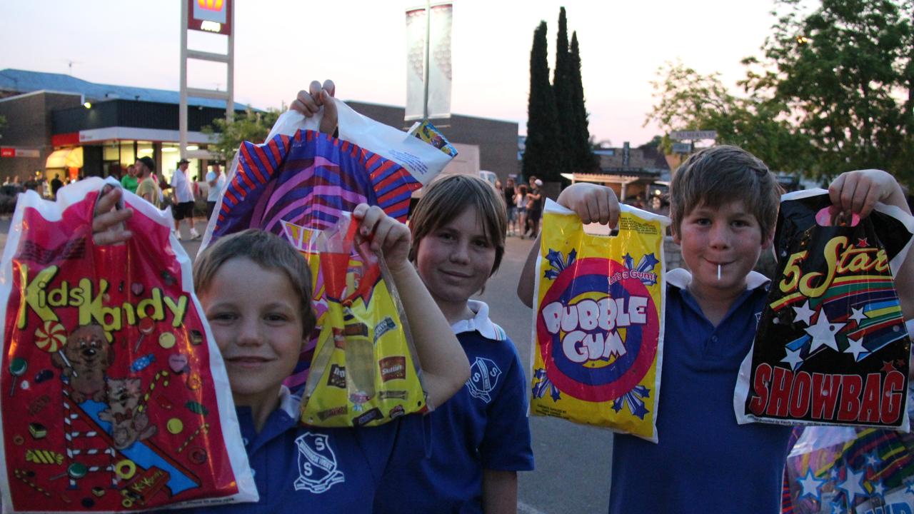 Brothers William, Henry and Edward Thomas got plenty of goodies in the showbags on sale at the Mardi Gras on Friday night. Photo: Erin Smith / Warwick Daily News