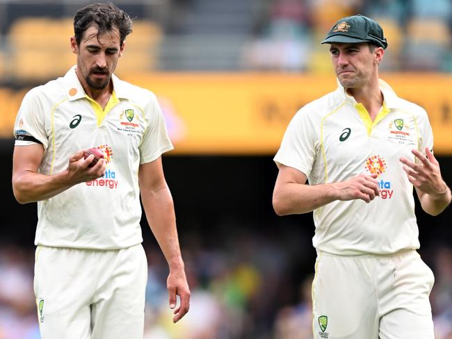 BRISBANE, AUSTRALIA - DECEMBER 17: Mitchell Starc and Pat Cummins of Australia speak during day one of the First Test match between Australia and South Africa at The Gabba on December 17, 2022 in Brisbane, Australia. (Photo by Bradley Kanaris/Getty Images)