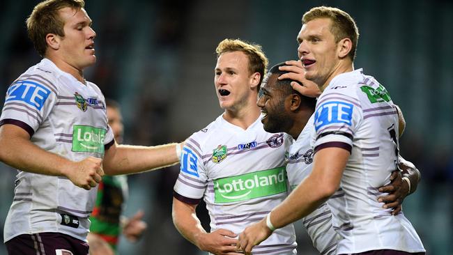 Akuila Uate celebrates with Sea Eagles teammates after scoring a try.