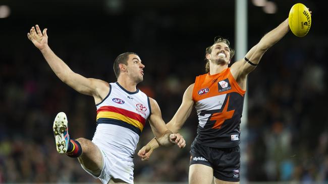 Crows captain Taylor Walker goes up against the Giants’ Harry Himmelberg. Picture: AAP Image/Rohan Thomson