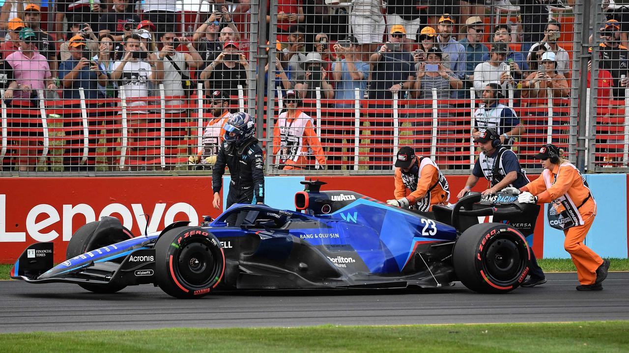 Marshalls push back Williams' Thai driver Alex Albon car on the track. Photo by William WEST / AFP.