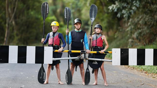 Junior kayakers Teddy Berry, 9, Angus Gonzo, 11, and Kitty Berry, 11, used to train frequently on the Barron River. Now, their closest training zone outside of the wet season is the Tully River, over two hours south of Cairns. Picture: Brendan Radke