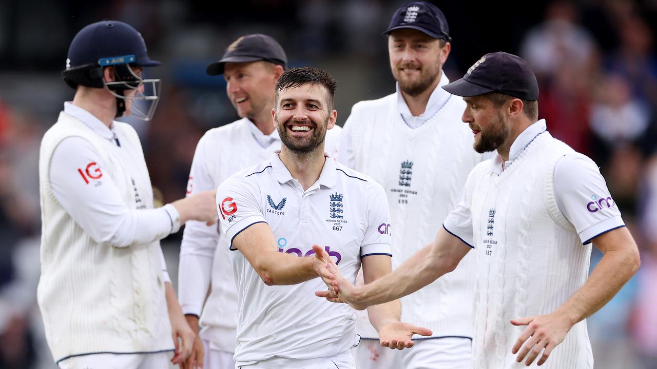Mark Wood of England celebrates with his teammates. Photo by Richard Heathcote/Getty Images