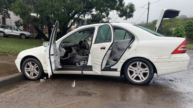 Receding flood water reveals extensive damage to a car in Hunter Street, Lismore, on March 1, 2022.