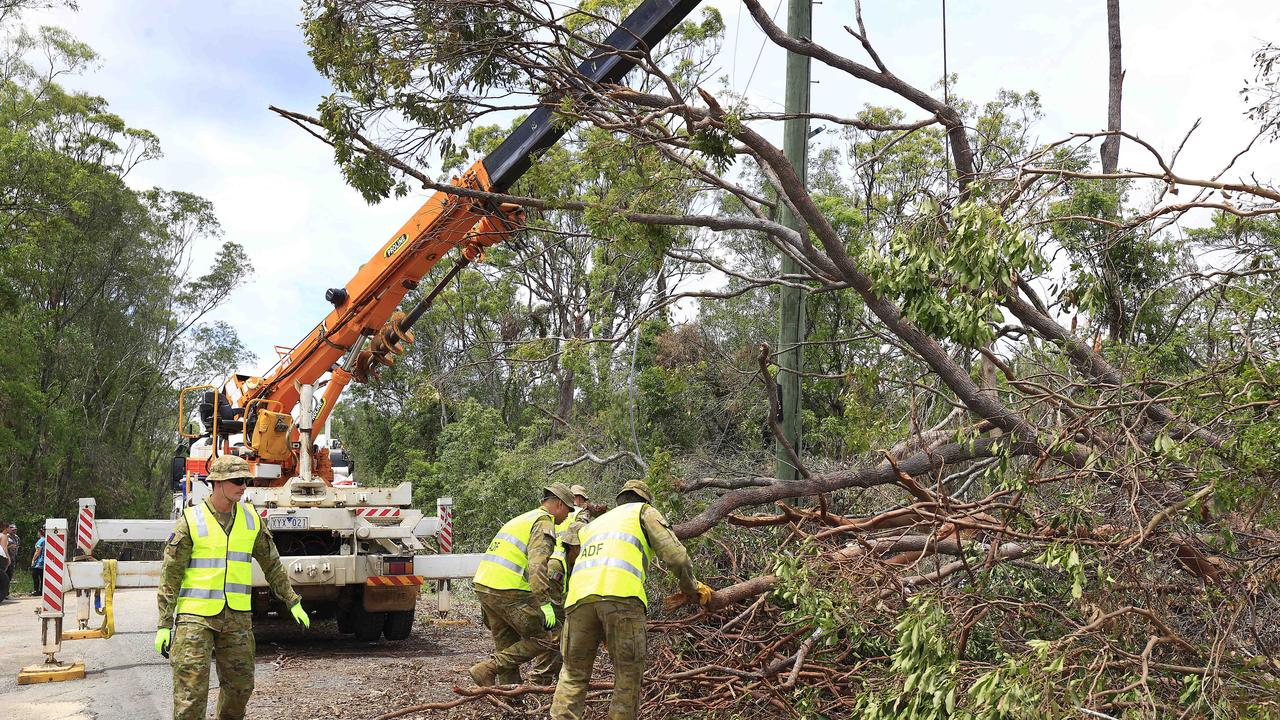 ADF help in the clean up at Kriedeman Road in Wongawallan after ferocious storms slammed the Gold Coast area. Pics Adam Head